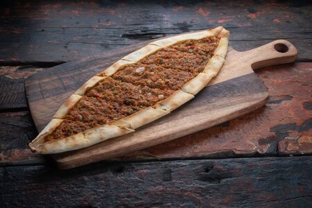 Turkish pide with vegetables isolated on rustic wooden tableの写真素材