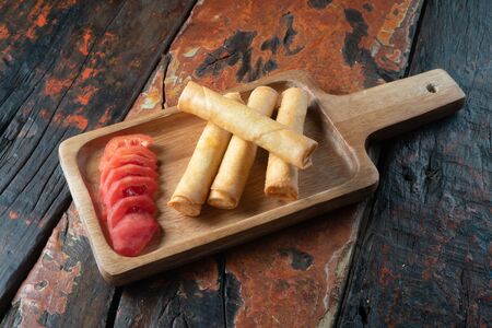 Spring rolls isolated on rustic wooden backgroundの写真素材