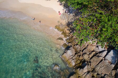 Aerial drone top view of turquoise sea surface with stones and rocks in waterの写真素材