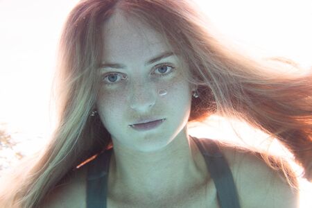 Closeup face of beautiful woman swimming underwaterの写真素材