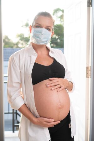 Pregnant woman in protective mask against flu and viruses. Healthcare conceptの写真素材