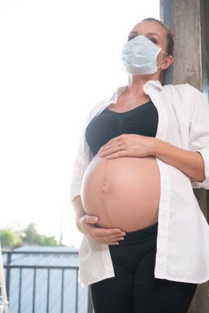 Pregnant woman in protective mask against flu and viruses. Healthcare conceptの写真素材