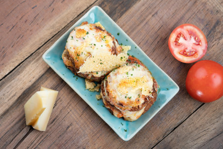 Pan fried crispy eggplant with parmesan cheese crust isolated on wooden tableの写真素材