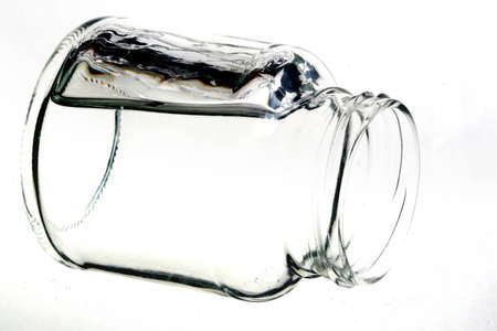 Small jar made from glass and stream of the waterの写真素材