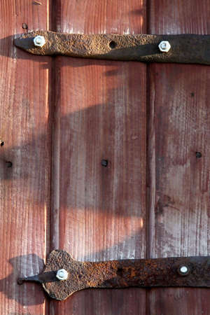 Red door on the hinges covered rust