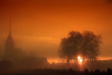 A church in the mist while sunsetの写真素材