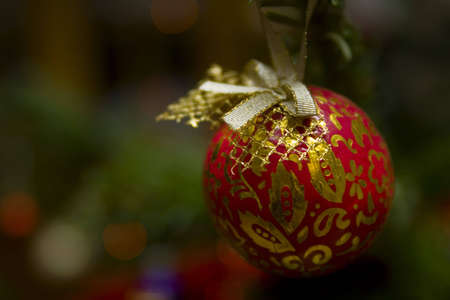 Red christmas ball with goldendecorstion on a treeの写真素材