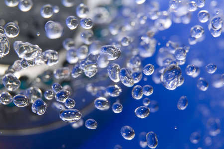 Colourless drops of water on the blue backgroundの写真素材
