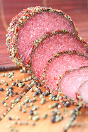 Slices of salami with pepper grainsの写真素材
