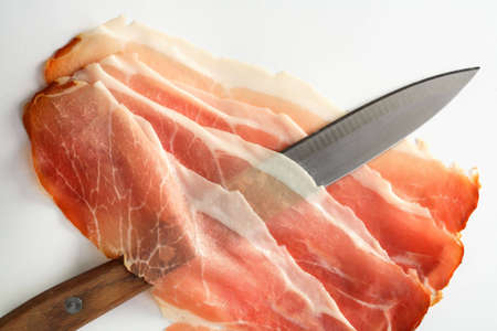 Slices of ham and knifeの写真素材