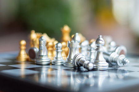 silver and gold chess on chess board game ,select focus