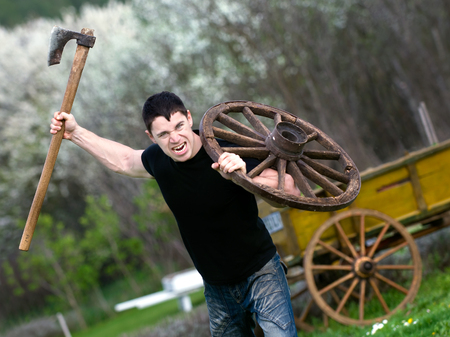 portrait of attacking young man with an ax in his hand