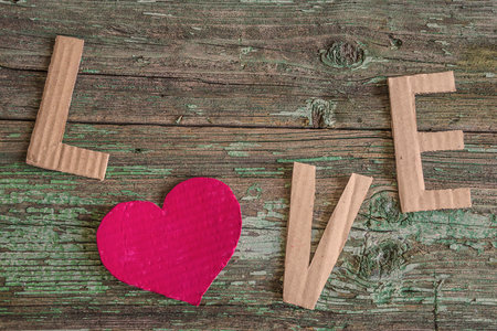 Valentine's day background with red heart on old wooden backgroundの写真素材