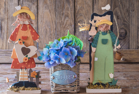 Garden gnomes with hydrangea flowers on wooden backgroundの写真素材