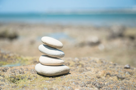 Pyramid of stones on the seashore. Zen concept.