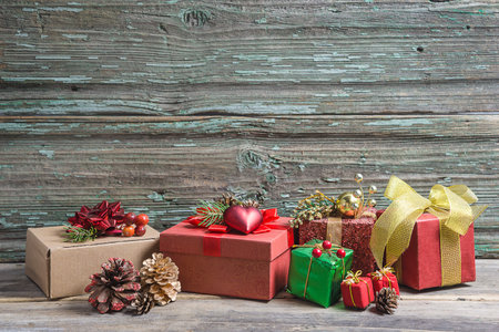 Gift boxes and christmas decoration on old wooden background with copy space
