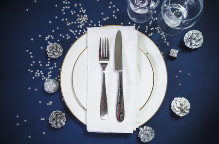 Vintage Christmas table setting with silverware and decorations. selective focus.