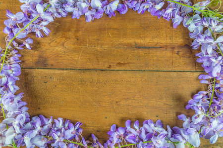 Wisteria flowers on wooden background with space for your text.の写真素材