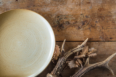 Empty plate on wooden background. Top view with copy space. vintage style.の写真素材