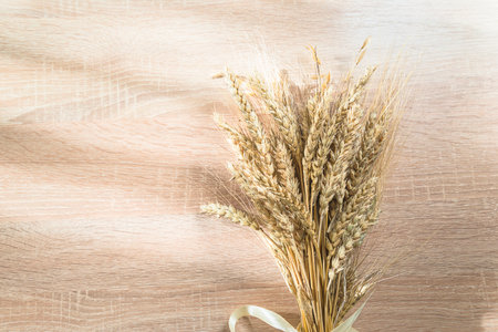 ears of wheat on a wooden background. top view, copy spaceの写真素材