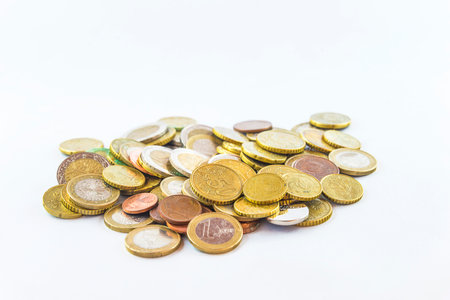 Heap of various metallic euro coins on white background