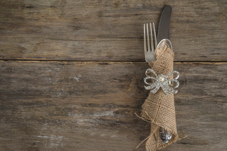 Fork, knife and napkin on wooden background with copy spaceの写真素材