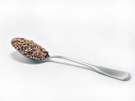 Steel spoon with buckwheatの写真素材