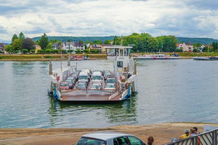 A car ferry in Linz on the Rhine wants to dock to release passengers with their carsの写真素材