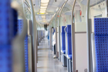 Center aisle and empty rows of seats in a bus