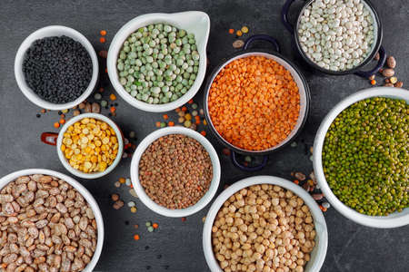 Many bowls of various legumes.Top viewの写真素材