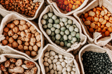 Various types of legumes in linen bags.Top view.の写真素材
