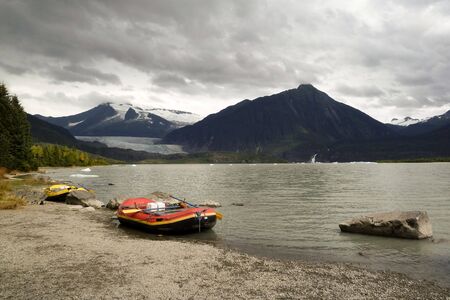 Alaskan lake view with floating ice and inflateable boatの写真素材