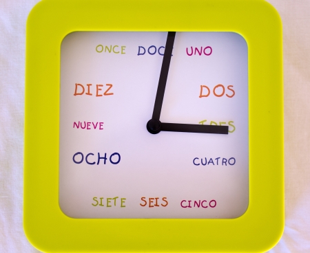 Spanish clock in bright green with coloured  hours in spanish