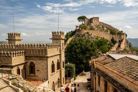 Xativa, Valenciana, Spain - Sept 17 2019 : View of Xativa small castle from walls of larger castle with tourists wandering around.のeditorial素材