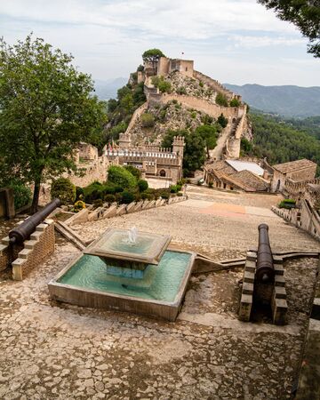 Xativa, Valenciana, Spain - Sept 17 2019 : View of Xativa small castle from walls of larger castle with tourists wandering around.のeditorial素材