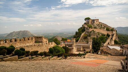 Xativa, Valenciana, Spain - Sept 17 2019 : View of Xativa small castle from walls of larger castle with tourists wandering around.のeditorial素材