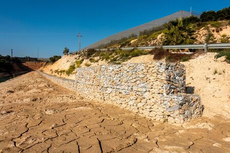 wall built from stones to prevent further landslideの写真素材
