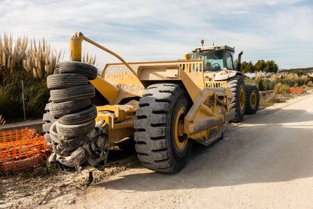 Torrevieja, Alicante, Spain - Jan 16 2020 : John Deere tractor towing earth moving equipment on...