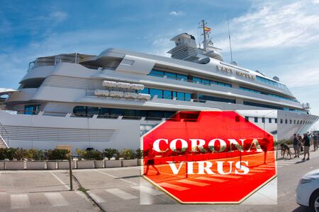 Large cruise ship at port with sign indicating warning of Coronavirus - infectious disease conceptのeditorial素材