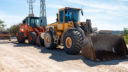 Torrevieja, Valenciana, Spain - Feb 26 2020 : heavy weight diggers parked in spanish urbanisationのeditorial素材