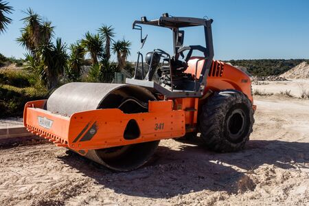 Torrevieja, Valenciana, Spain - Feb 27 2020 : heavy weight road roller parked in spanish urbanisationのeditorial素材