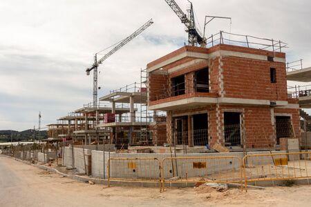 new homes under construction on spanish urbanisation with cranesの写真素材