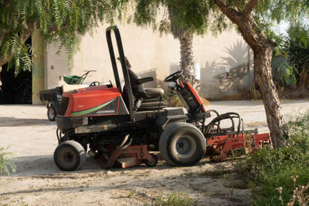 Torrevieja, Valenciana, Spain - May 04 2020 : ride on lawnmower on urbanisation in spainのeditorial素材