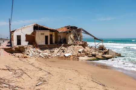 Valenciana, Spain - June 01 2020 : Storm damaged house and beach in Guardamarのeditorial素材