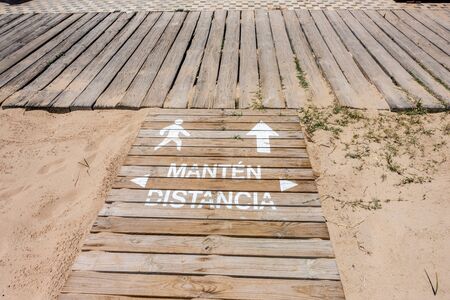 social distance sign on beach walkway in Spainの写真素材