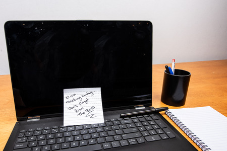 laptop in office with paper noteの写真素材