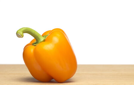 Yellow Pepper on chopping boardの写真素材