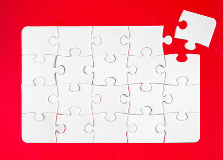 Jigsaw pieces with a red backgroundの写真素材