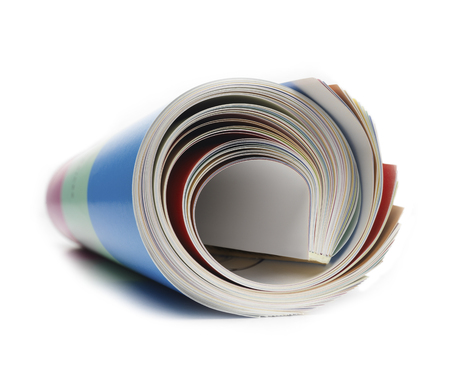 Rolled up magazine on whiteの写真素材