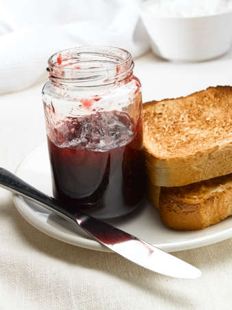 Jam and toast on breakfast tableの写真素材